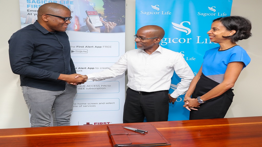 Executive Vice President of the Employee Benefits Division (EBD), Sagicor Life, Willard Brown (centre), greets Managing Partner, First Responder’s Technology Limited, Aldain Reid